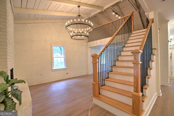 a view of entryway and hall with wooden floor