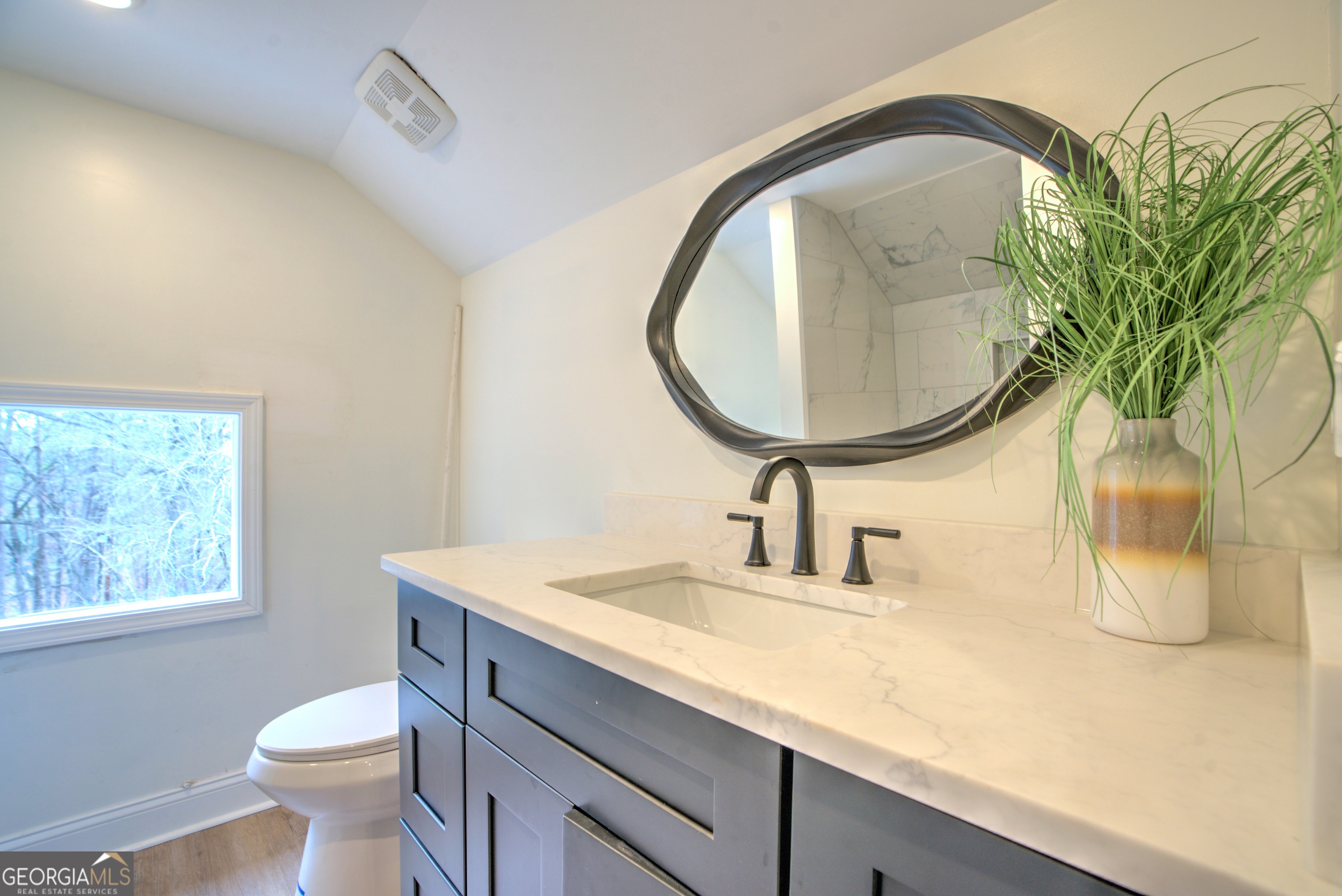 205 Mt Alto Road Southwest Rome, GA 30165 - Photo 28 of 36 a bathroom with a toilet sink and mirror