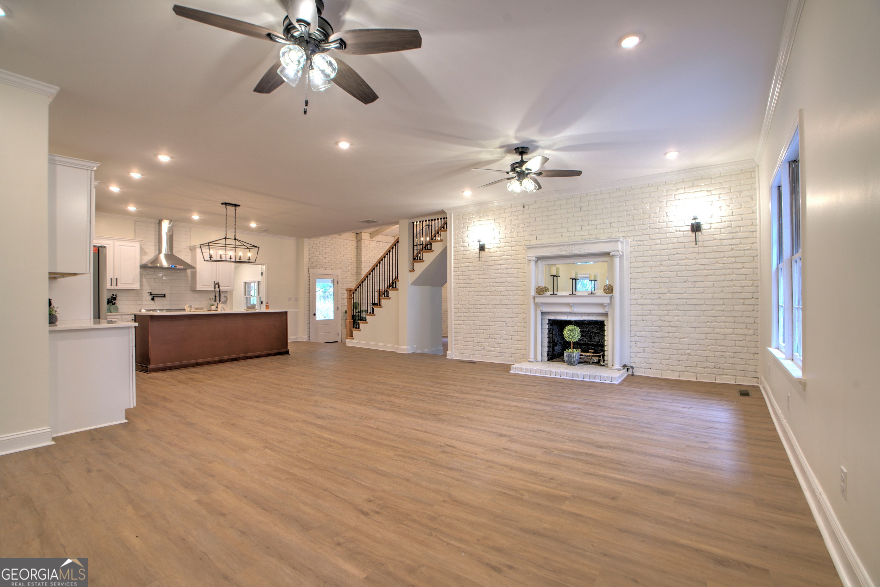205 Mt Alto Road Southwest Rome, GA 30165 - Photo 6 of 36 a view of an empty room with a fireplace and a chandelier fan