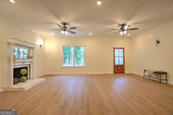 wooden floor in an empty room with a fireplace