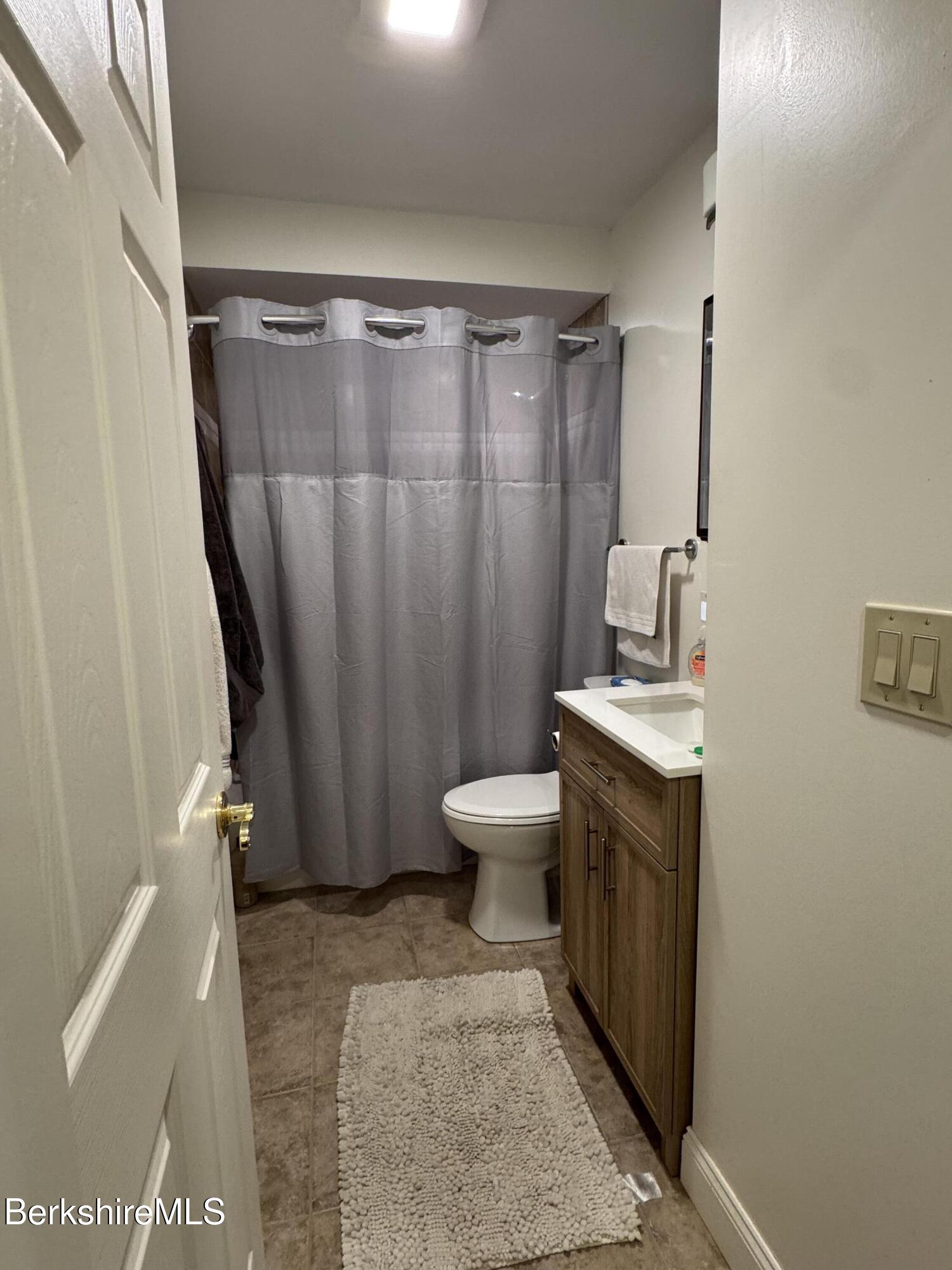 189 Stratton Road Williamstown, MA 01267 - Photo 11 of 13 a bathroom with a granite countertop sink toilet and shower