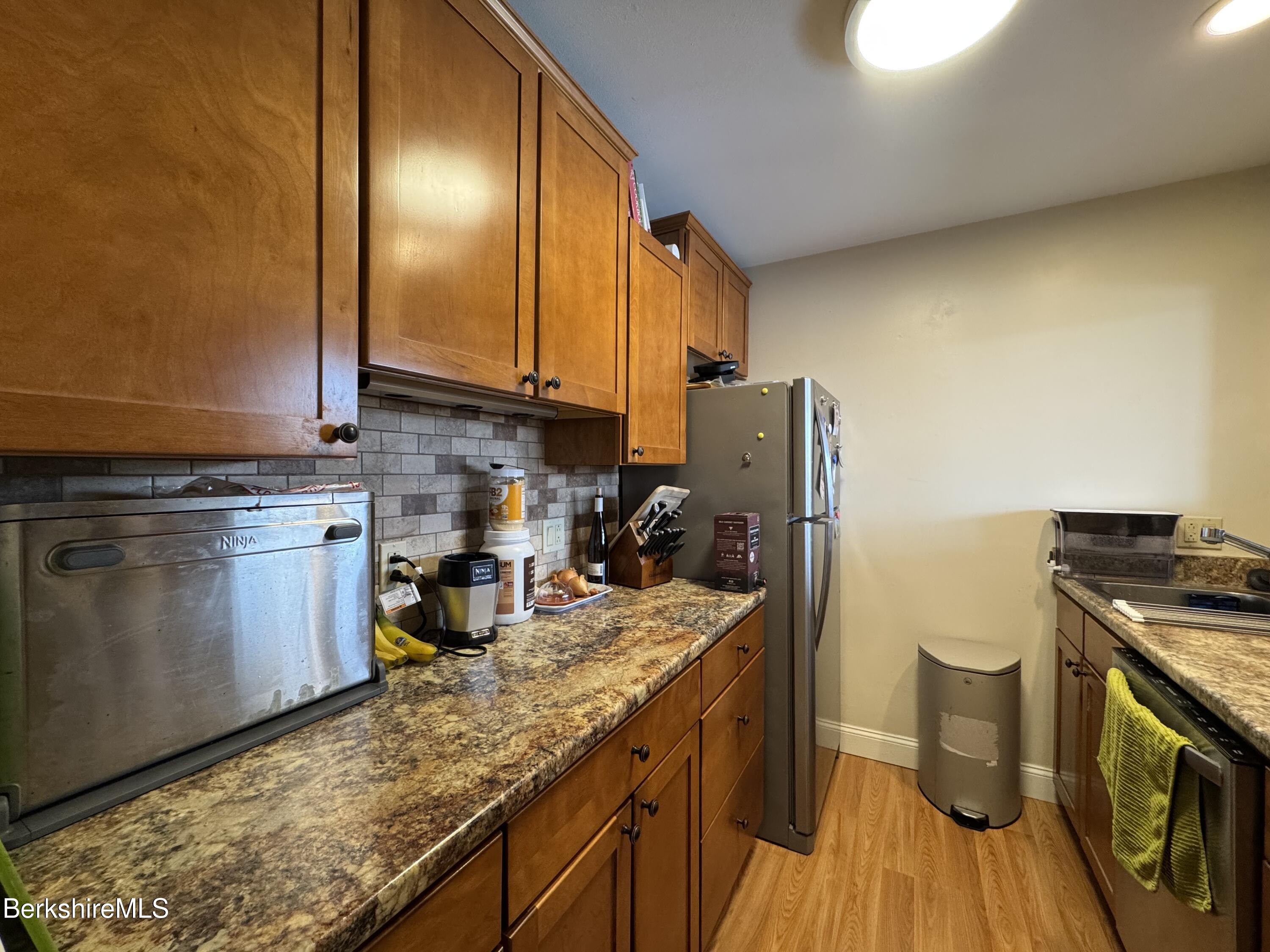 189 Stratton Road Williamstown, MA 01267 - Photo 2 of 13 a kitchen with sink cabinets and stove top oven
