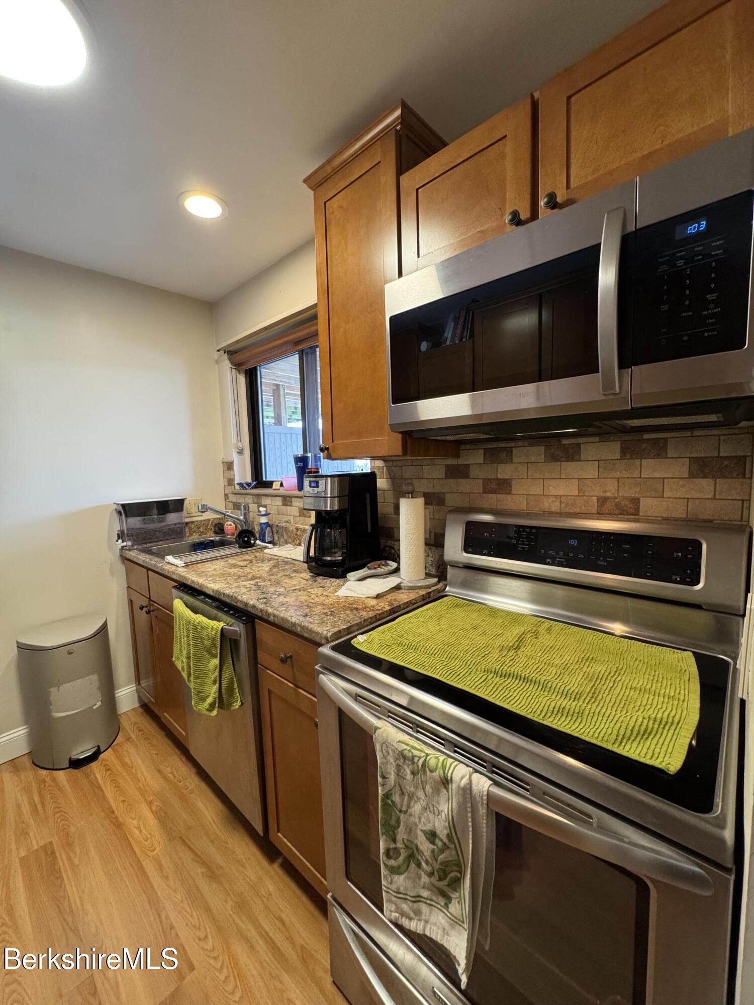 189 Stratton Road Williamstown, MA 01267 - Photo 3 of 13 a kitchen with stainless steel appliances a stove a sink and a microwave