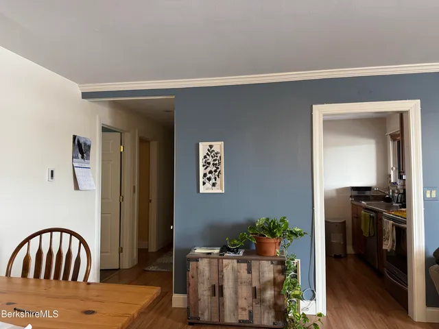 a view of a hallway to a livingroom with furniture