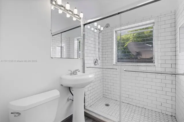 a bathroom with a sink toilet and shower