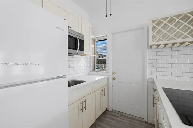 a kitchen with a sink and a microwave