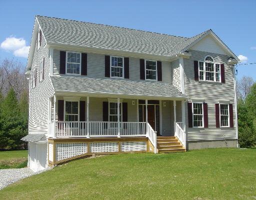 a view of a house with a yard and a large park