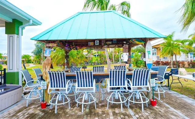 a view of a swimming pool with a patio and a yard