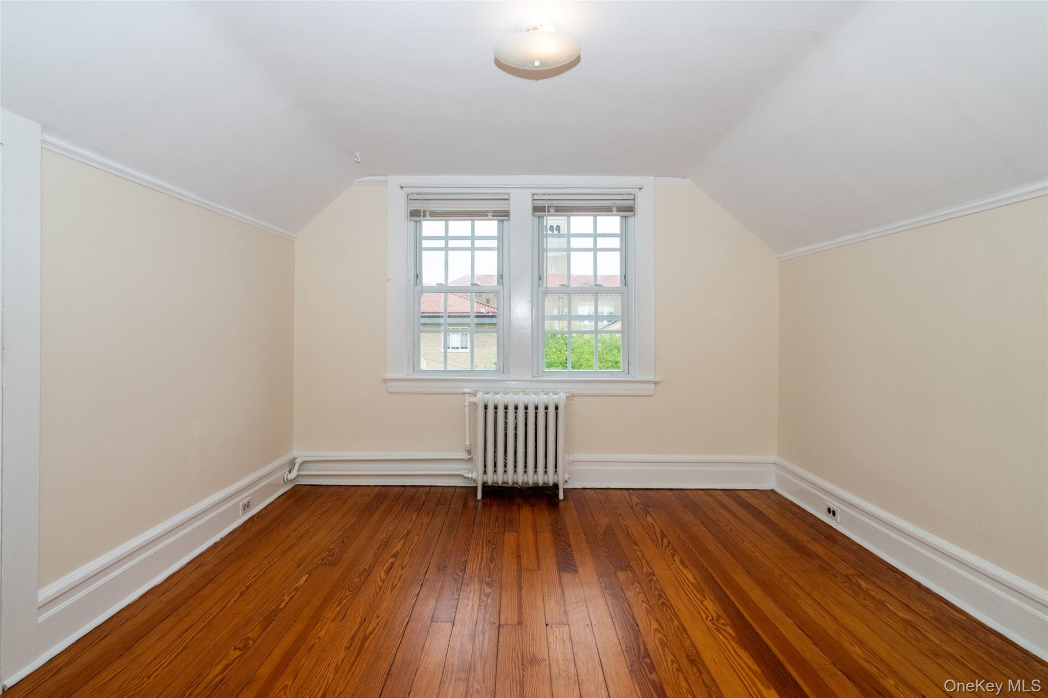 82 Clove Road New Rochelle, NY 10801 - Photo 26 of 39 an empty room with wooden floor and windows