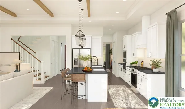 a large white kitchen with a large window and stainless steel appliances