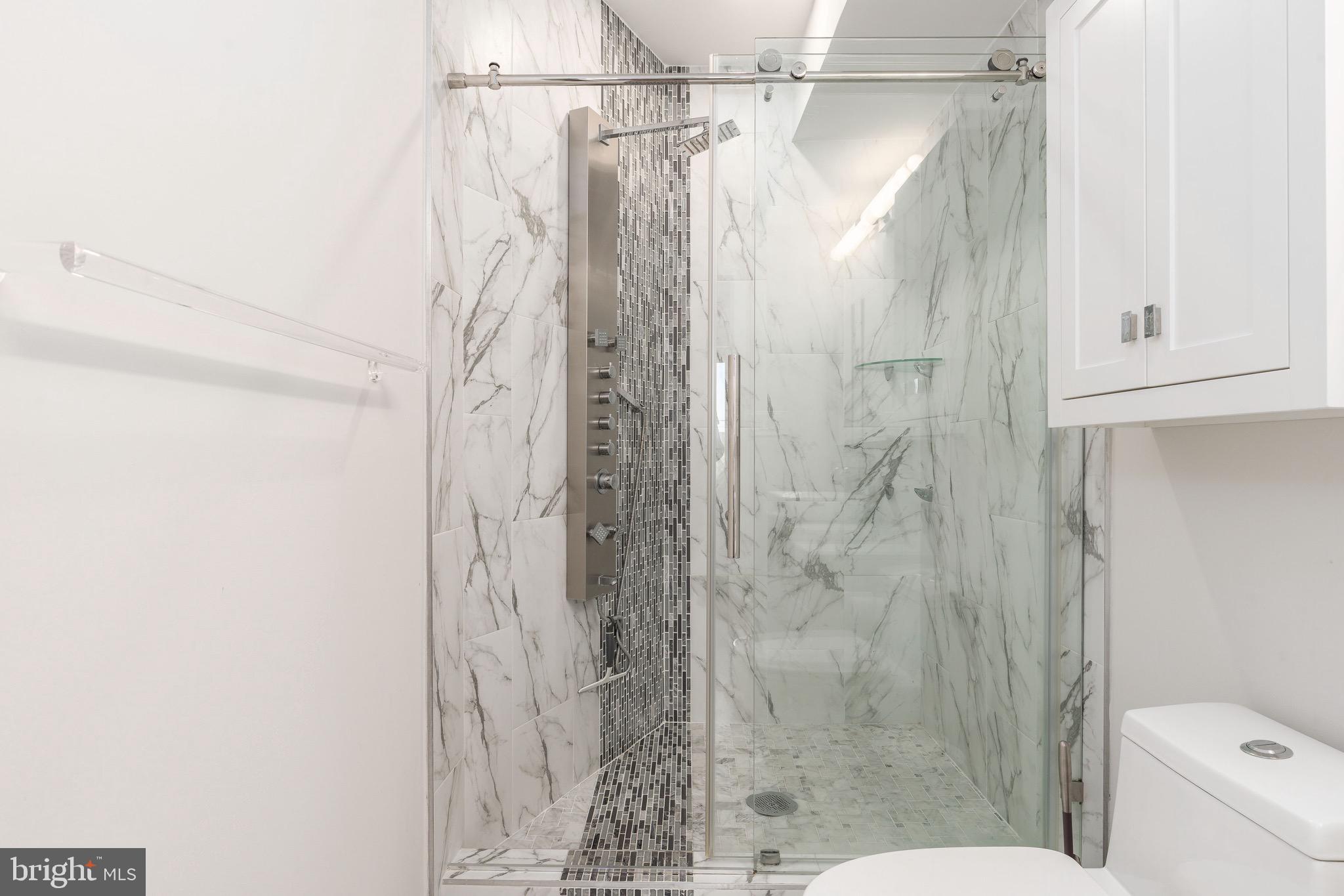 1733 Carpenter Street, Unit D Philadelphia, PA 19146 - Photo 23 of 37 a bathroom with a shower and toilet