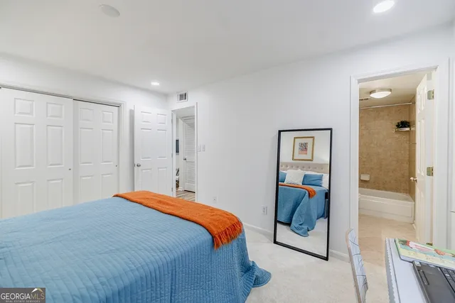 a bedroom with a bed and glass door