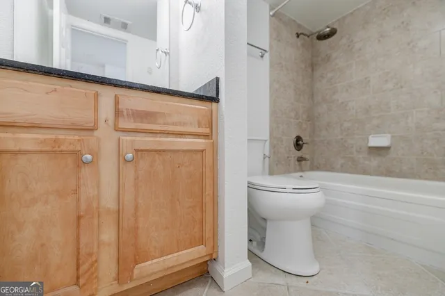 a bathroom with a toilet sink and shower