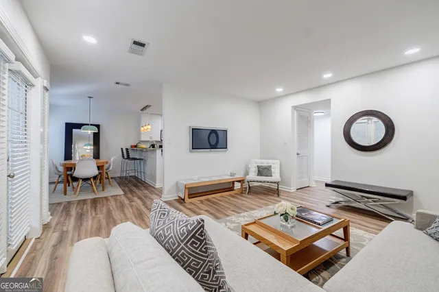 a living room with furniture rug and window