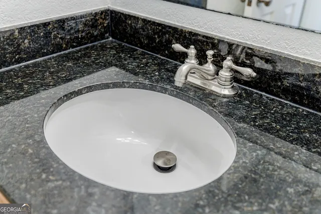 closeup of a sink with wooden floor