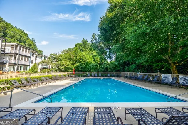 a view of a swimming pool with an outdoor space and seating area