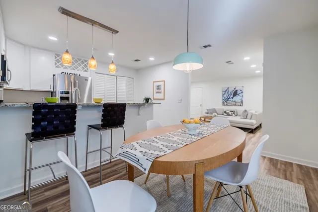a view of a dining room with furniture and wooden floor