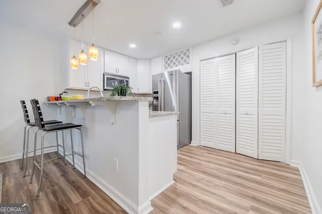 a kitchen with stainless steel appliances a refrigerator and a stove top oven