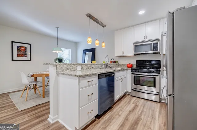 a kitchen with a stove oven and a refrigerator