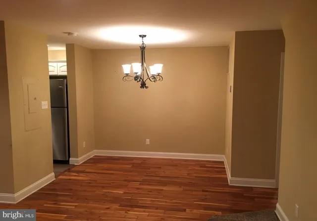 an empty room with wooden floor