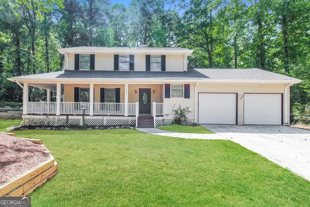 a house that has a big yard with wooden fence