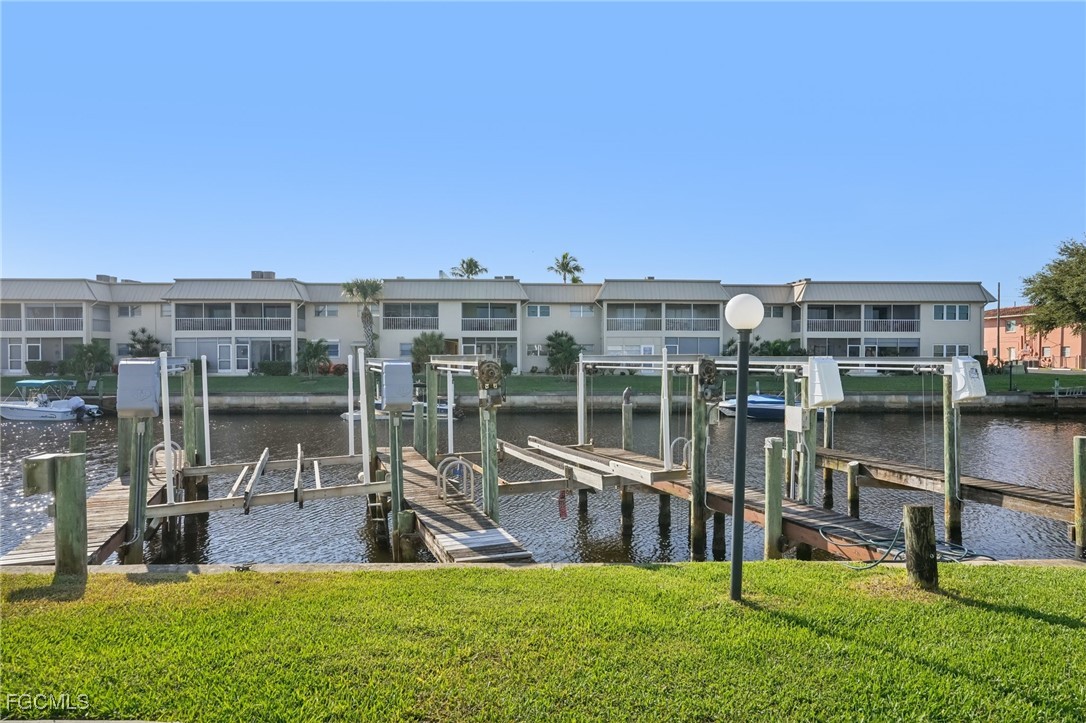 1006 Southeast 46th Street, Unit 1C Cape Coral, FL 33904 - Photo 19 of 26 a view of a swimming pool with a yard and sitting space