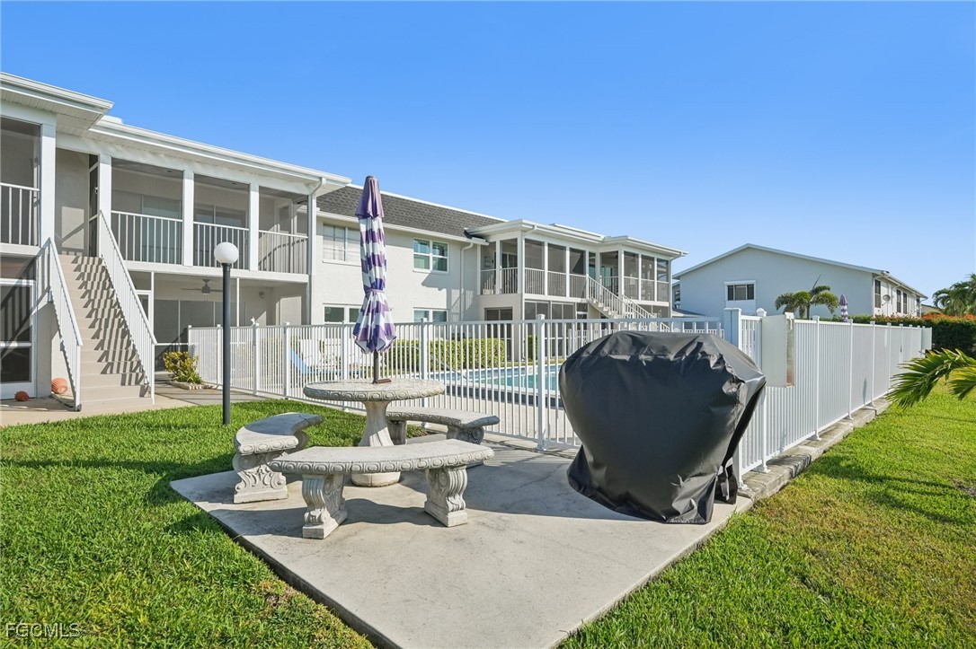 1006 Southeast 46th Street, Unit 1C Cape Coral, FL 33904 - Photo 21 of 26 a view of a house with backyard sitting area and garden