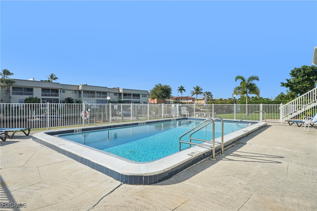 1006 Southeast 46th Street, Unit 1C Cape Coral, FL 33904 - Photo 22 of 26 a view of a swimming pool with a lounge chair