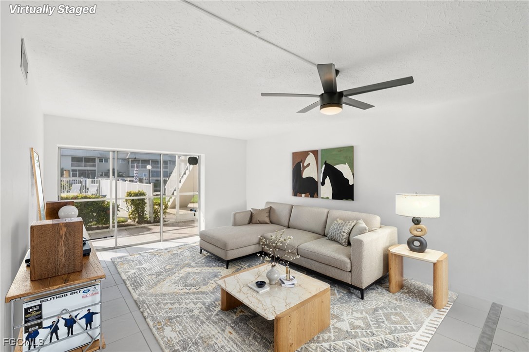 1006 Southeast 46th Street, Unit 1C Cape Coral, FL 33904 - Photo 4 of 26 a living room with furniture and a ceiling fan