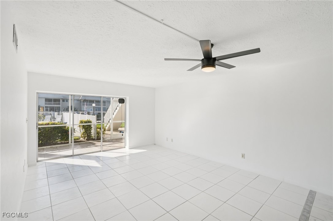 1006 Southeast 46th Street, Unit 1C Cape Coral, FL 33904 - Photo 5 of 26 an empty room with floor to ceiling window