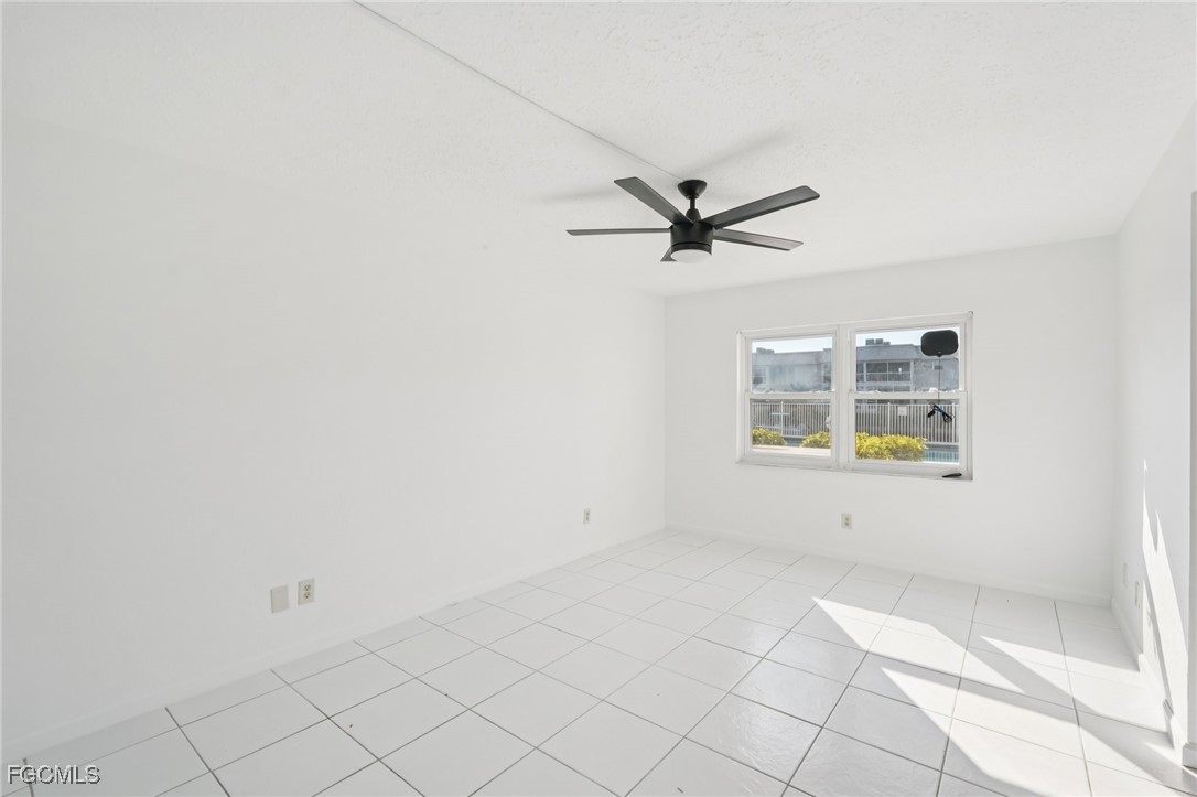 1006 Southeast 46th Street, Unit 1C Cape Coral, FL 33904 - Photo 8 of 26 a view of a livingroom with a ceiling fan and window