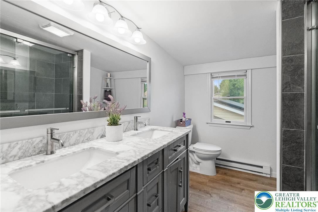 368 Meyer Road Nazareth, PA 18064 - Photo 31 of 66 a bathroom with a granite countertop sink a toilet and a mirror