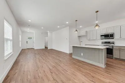 a view of kitchen with sink and microwave