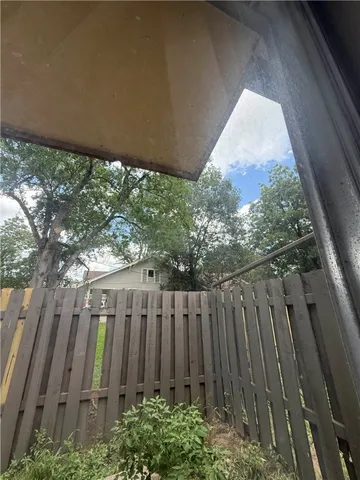 a view of a backyard with wooden fence