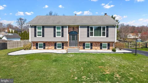 a view of a house with a yard and sitting area