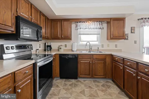 a kitchen with a sink stove top oven and cabinets