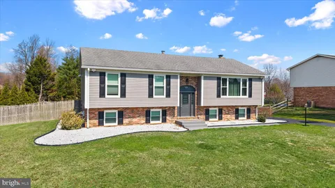a view of a house with a yard porch and sitting area