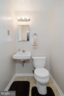 a bathroom with a sink toilet and mirror