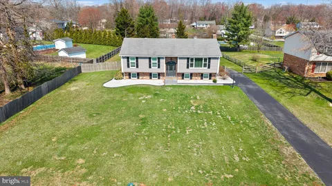 an aerial view of a house with swimming pool garden and lake view