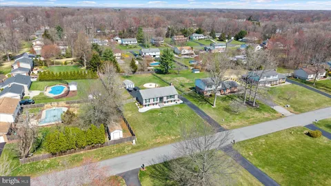an aerial view of a residential houses with outdoor space