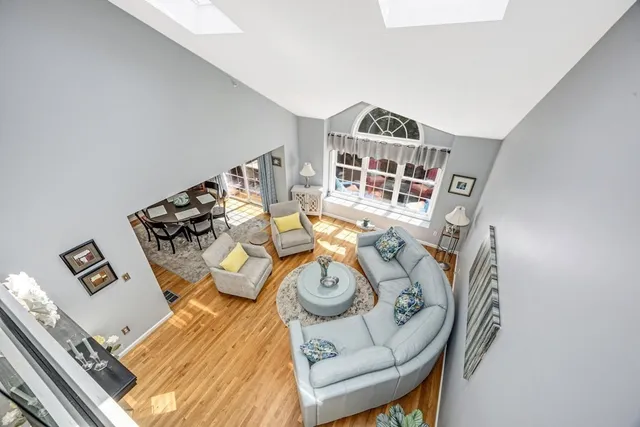 a living room with furniture and a floor to ceiling window