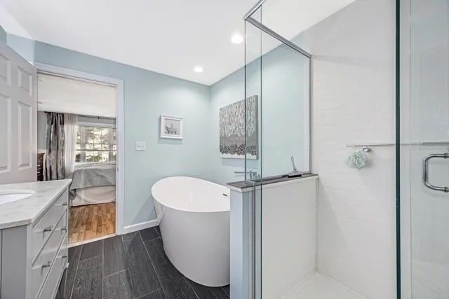 a bathroom with a sink a toilet and shower