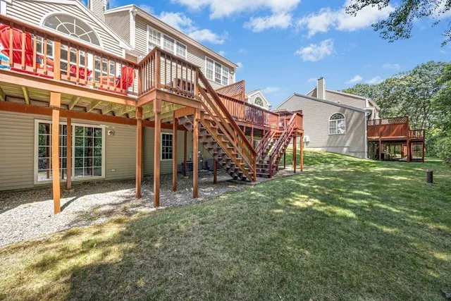 a view of a house with a yard and a wooden fence