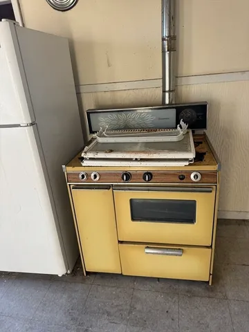 a bathroom with a granite countertop toilet sink and mirror