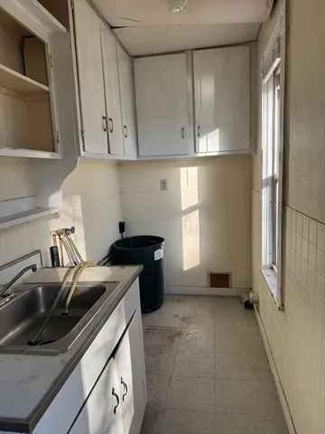 a stove top oven sitting inside of a kitchen