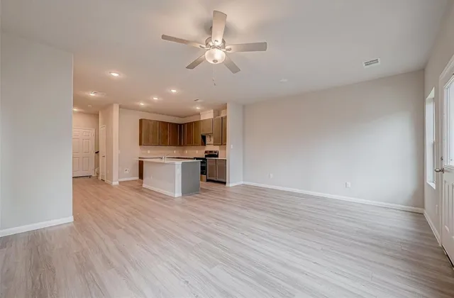 a view of kitchen with stove and wooden floor
