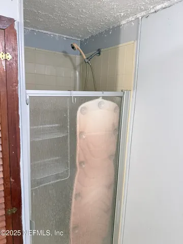 a bathroom with a glass shower door