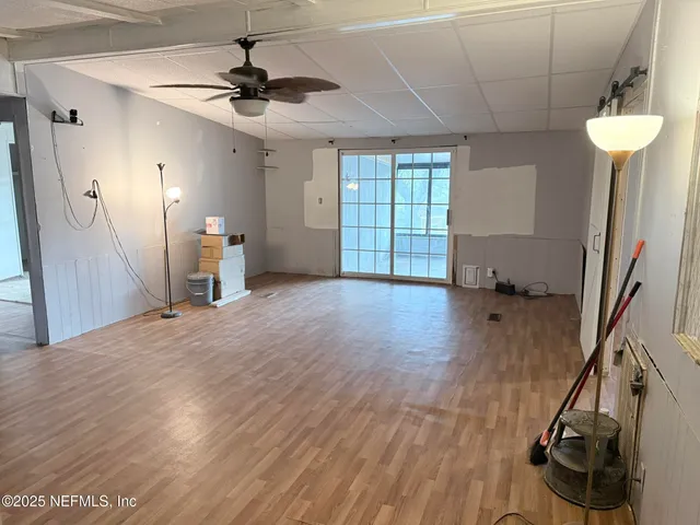 a view of a room with wooden floor and windows