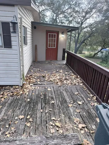 a view of backyard with deck and wooden floor