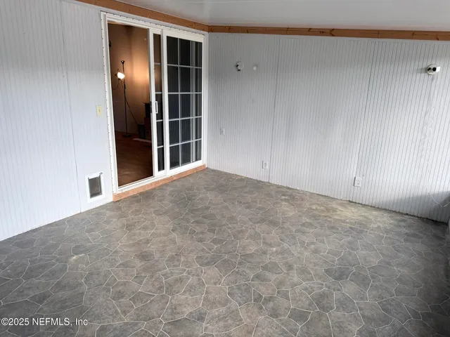 a view of an empty room with closet area